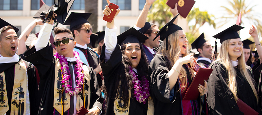 Graduates cheering at a commencement ceremony